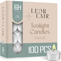 Box of Leor & Lair tealight candles with a single candle lit on a white background